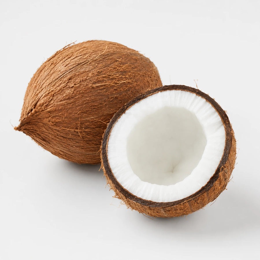 One whole coconut and one cut coconut half showing fresh white flesh on a light background.