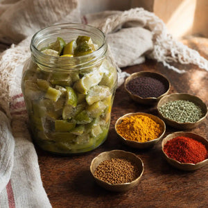 Softened limes resting beside bowls of traditional pickle spices.