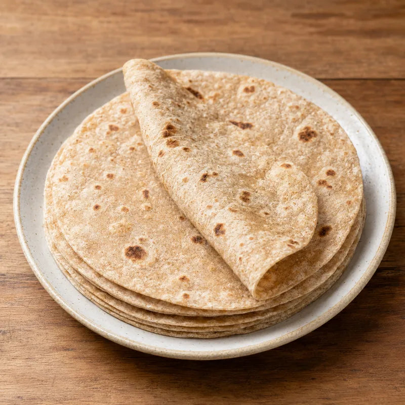 Stack of soft whole-wheat rotis with natural toasted brown spots